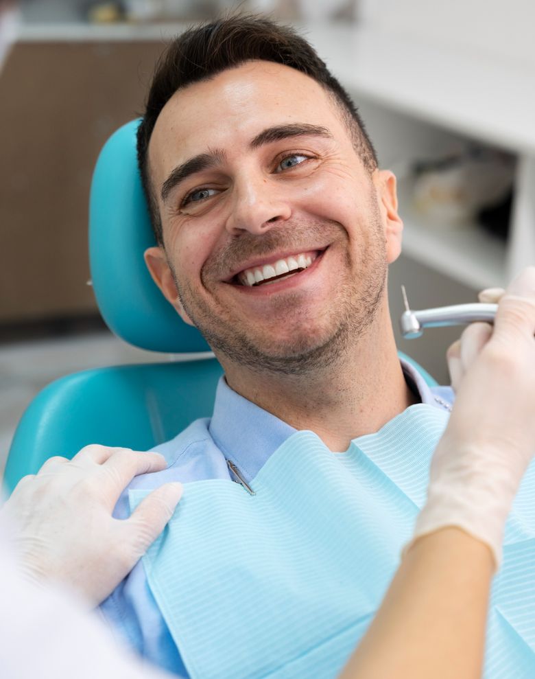 Smiling man receiving dental implant treatment at Implant Network clinic in Ontario, Canada